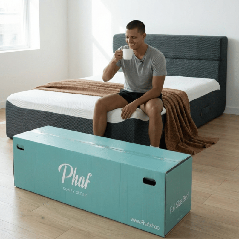 Man sitting on a bed with a Phaf mattress box in the foreground