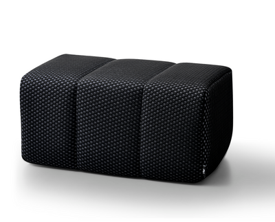 Black Toto Ottoman by Phaf showcasing a sleek, modern design with plush upholstery and sturdy wooden legs.